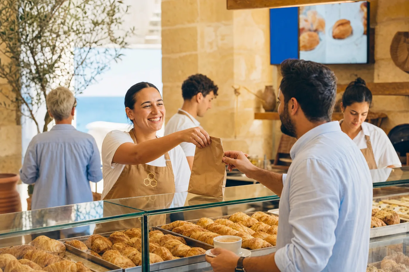 The pastizzeria counter in the morning, a bag of pastizzi handed over with a coffee